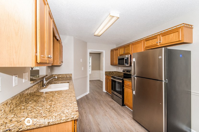 a kitchen with stainless steel appliances and granite counter tops