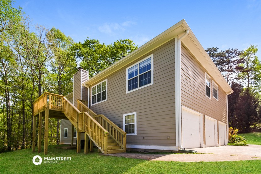 a house with a wooden deck on the side of it