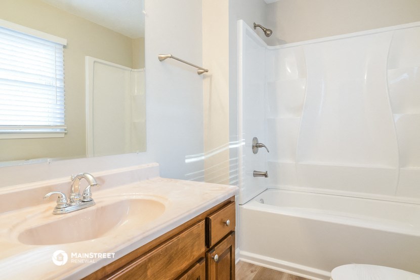 a bathroom with a sink and a tub and a shower