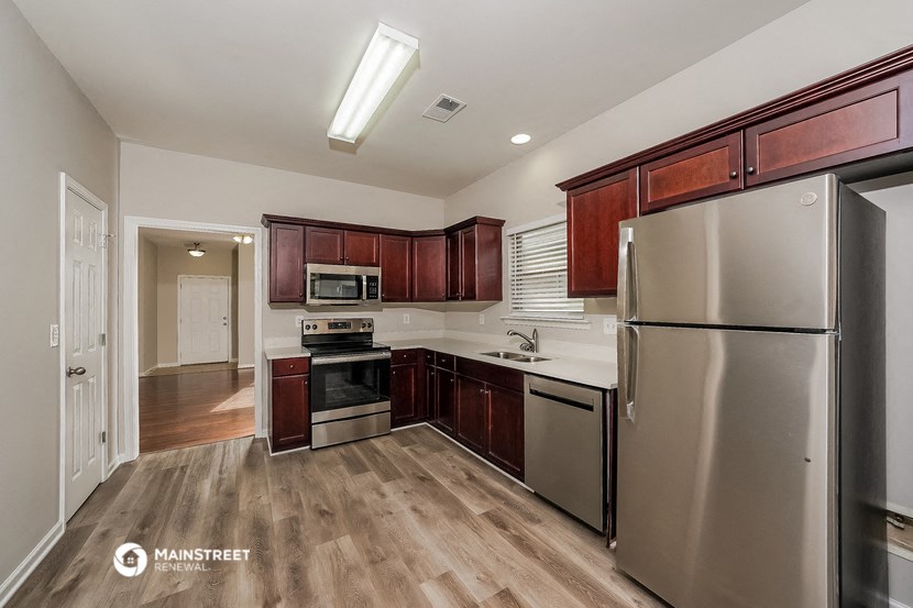 a kitchen with stainless steel appliances and wooden cabinets