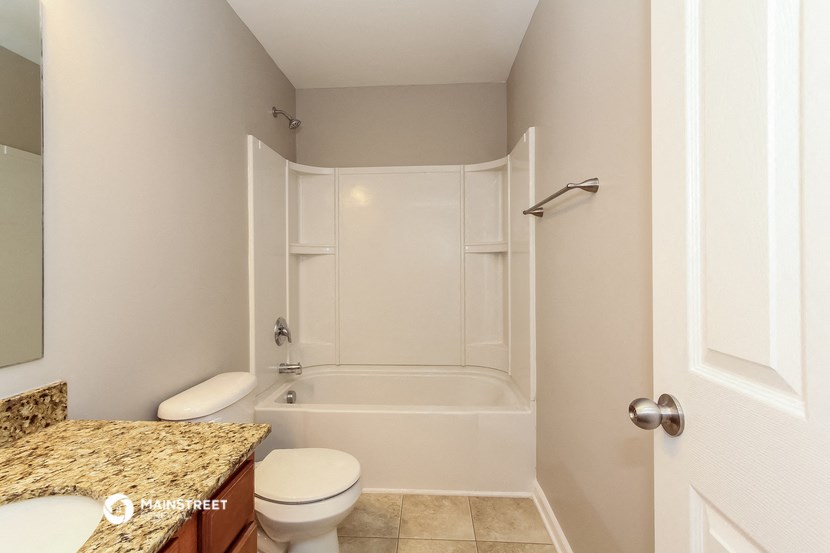 a bathroom with a shower and a sink and a toilet