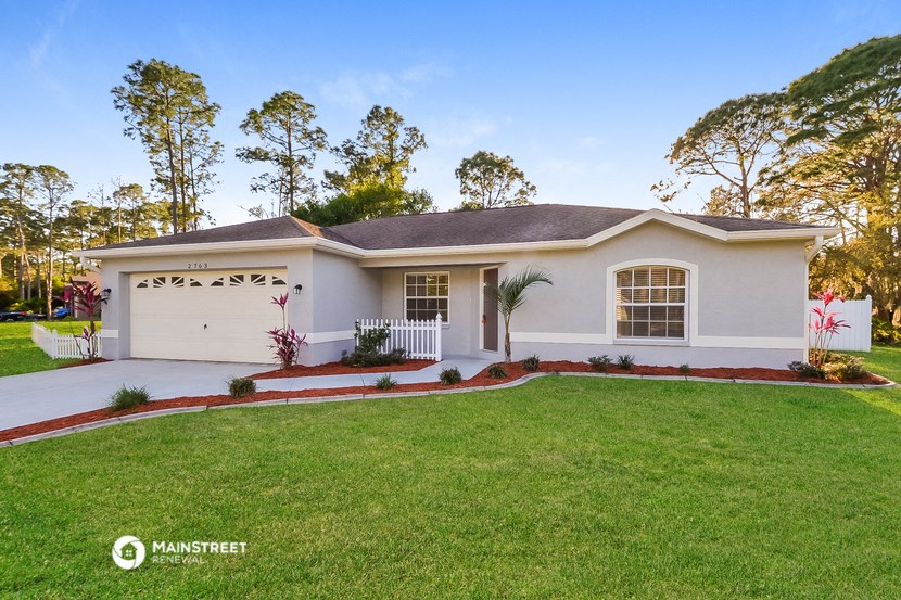 a white house with a lawn in front of it