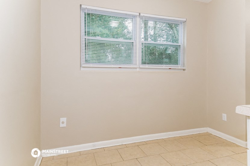 a room with a window and a tiled floor