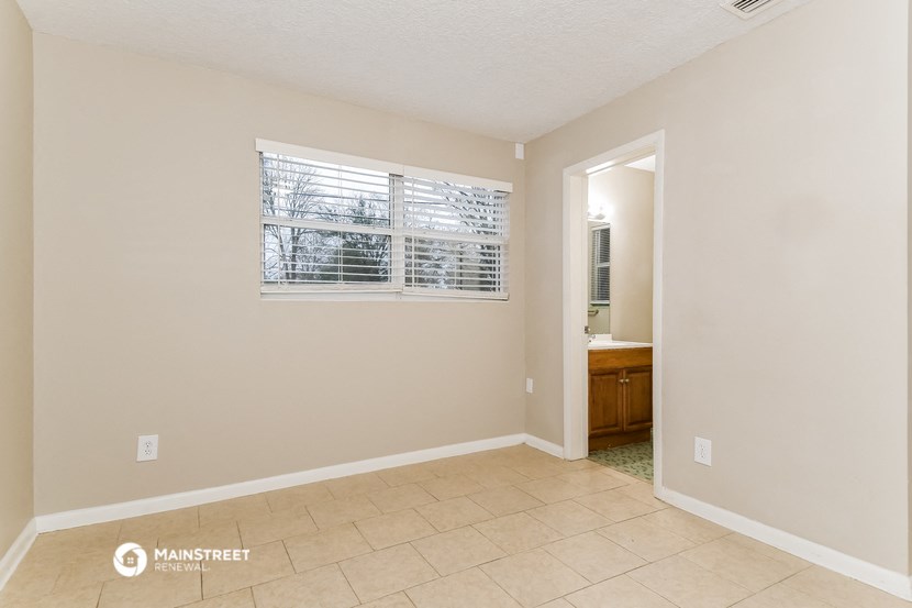 the living room of an empty house with a large window