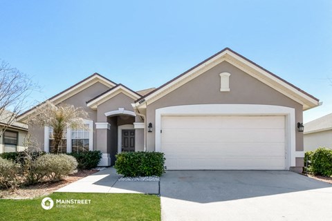 a house with a white garage door and a lawn