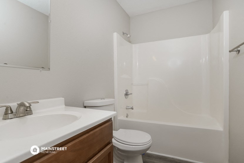 a bathroom with a sink toilet and a shower