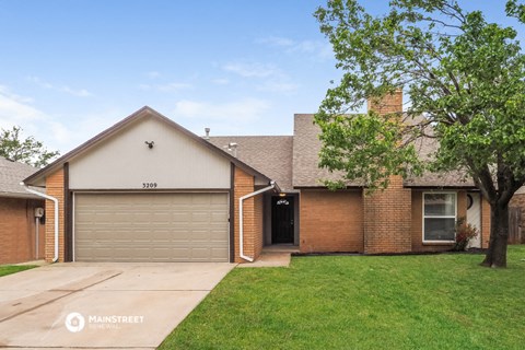 a house with a yard and a garage door
