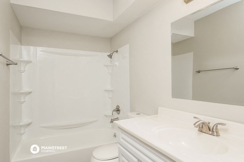 a bathroom with a sink and a toilet and a shower