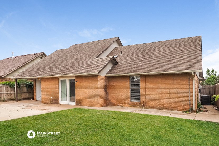 a brick house with a yard in front of it