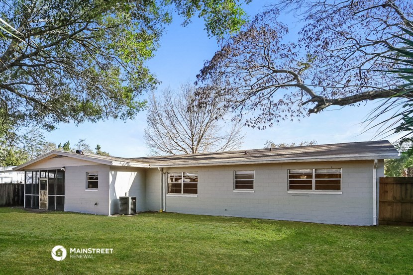 a white house with a yard and trees