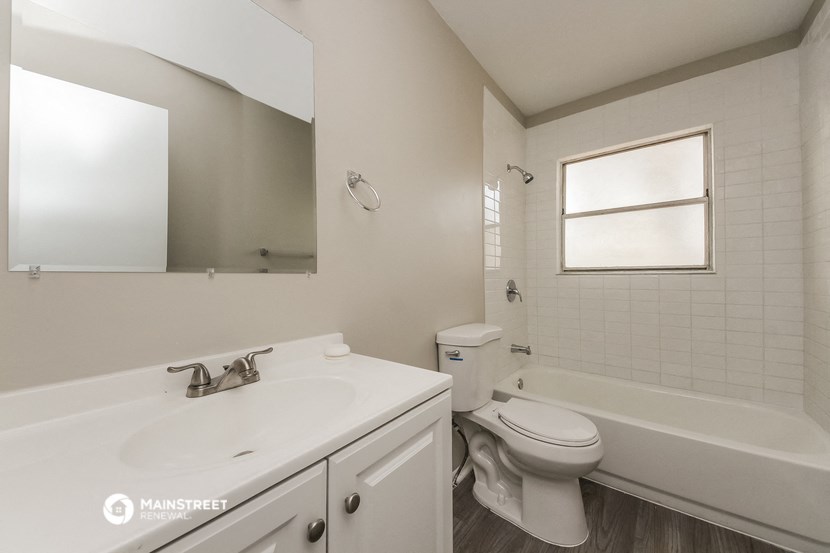 a bathroom with a sink and a toilet and a tub