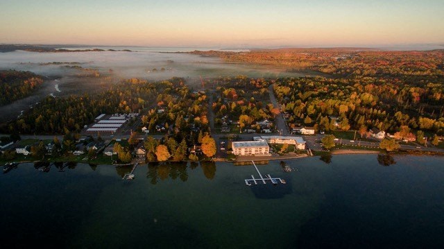 an aerial view of a body of water with a boat