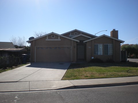 the front of a house with a driveway and a garage door
