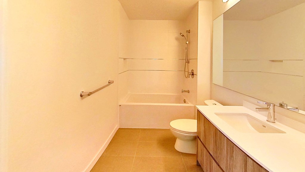 a bathroom with a toilet and a tub and a sink