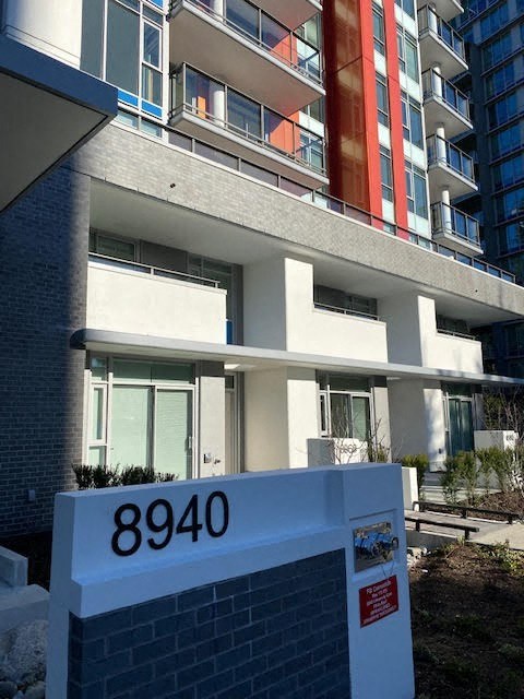 an apartment building with a sign in front of it