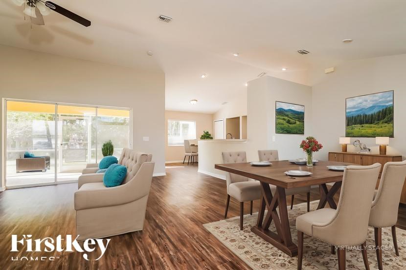 A dining room with a wooden table and chairs.