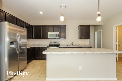 a kitchen with stainless steel appliances and a marble counter top