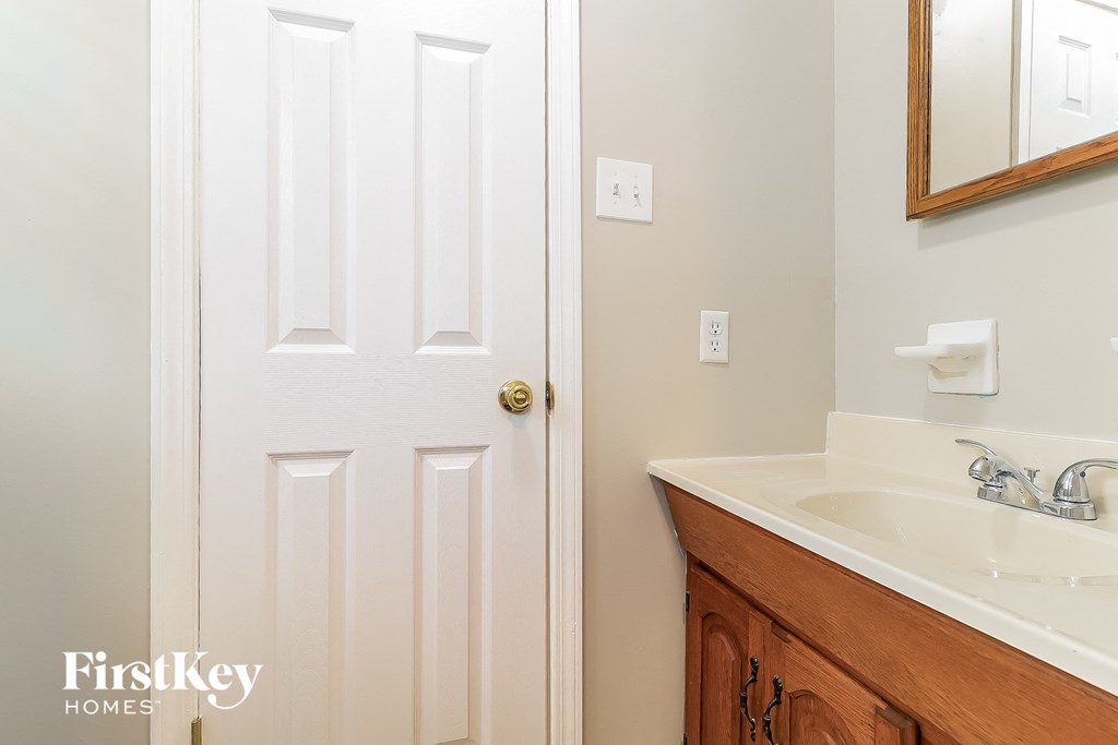 a bathroom with a sink and a white door