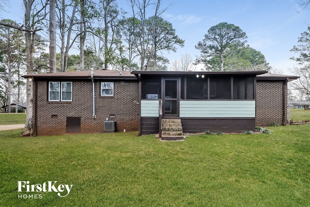 a small brick house with a white and black door