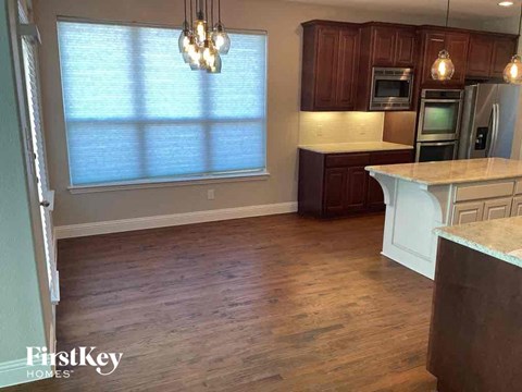 A kitchen with wooden cabinets and a white countertop.