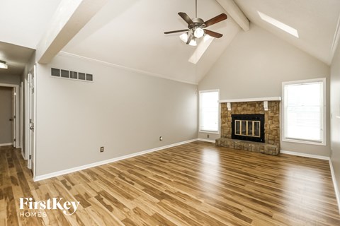 the living room has a fireplace and hardwood floors