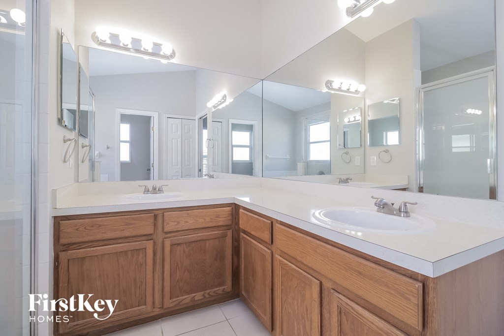 a large bathroom with two sinks and a large mirror