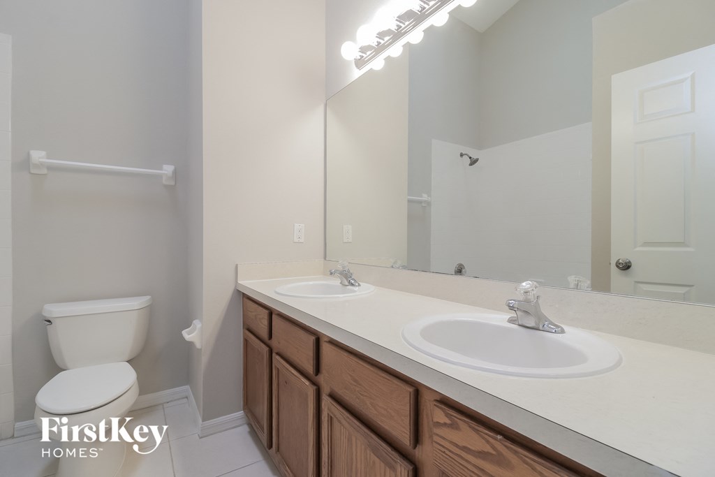 a bathroom with a toilet and a sink and a mirror