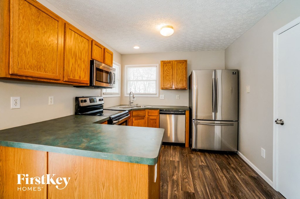 a kitchen with stainless steel appliances and wooden cabinets