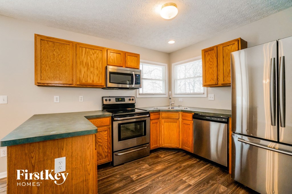 a kitchen with stainless steel appliances and wooden cabinets