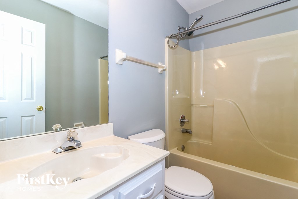 a bathroom with a sink and a shower and a toilet