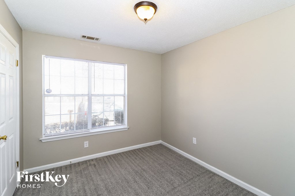 the living room of an empty home with a large window