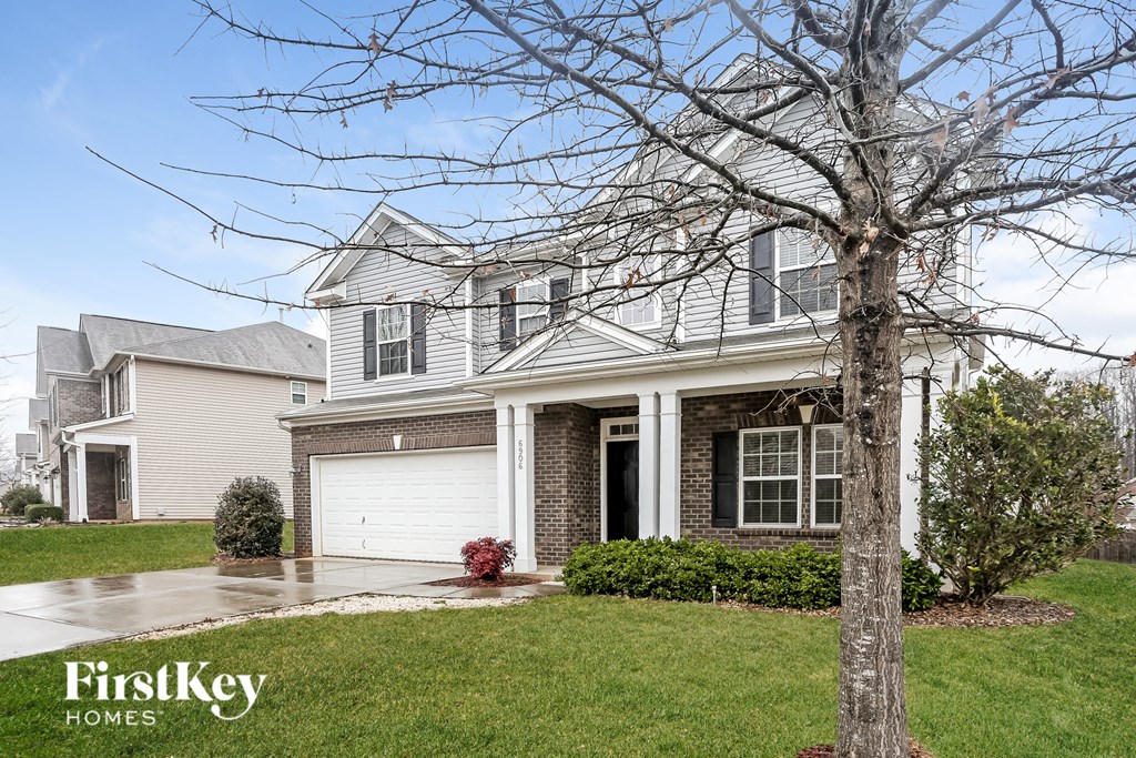 A house with a tree in front of it.