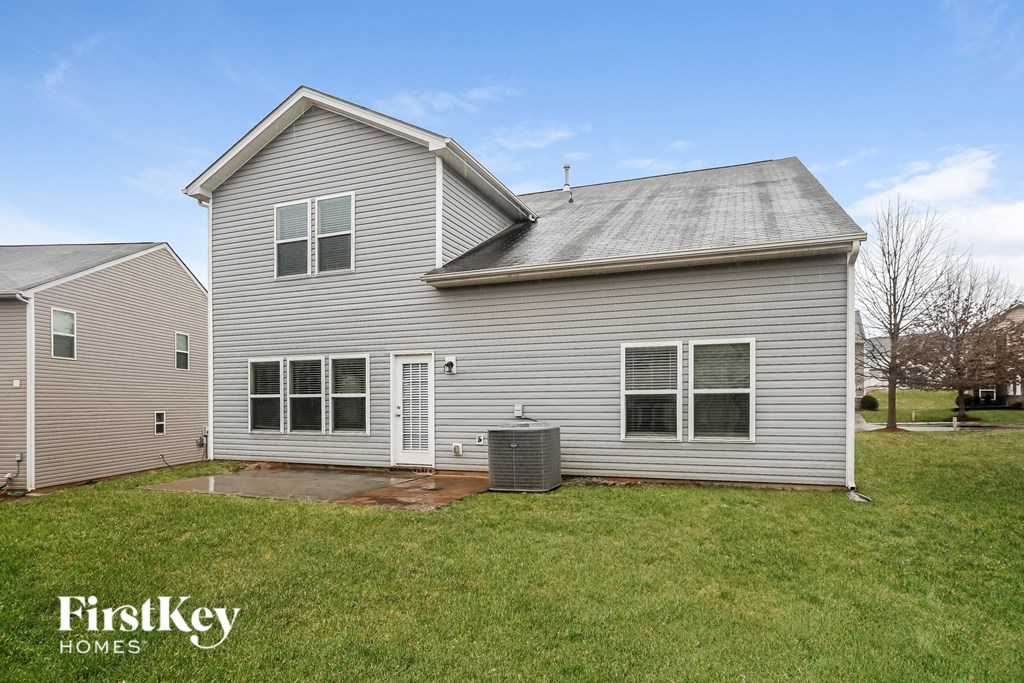 A house with a grey roof and a white door is shown.