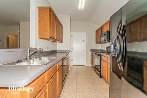 a kitchen with stainless steel appliances and wooden cabinets
