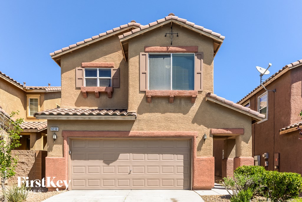 a house with a garage door in front of it