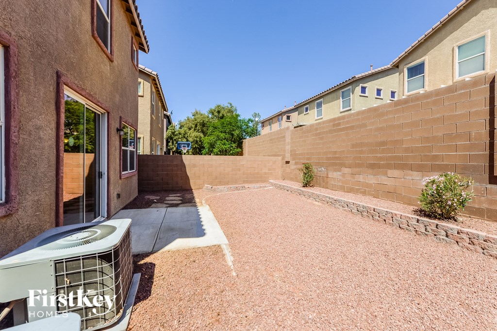 a patio next to a brick building with a fence