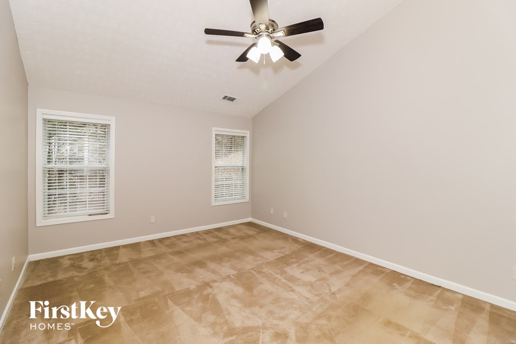 the living room of a home with a ceiling fan