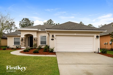 a beige house with a white garage door