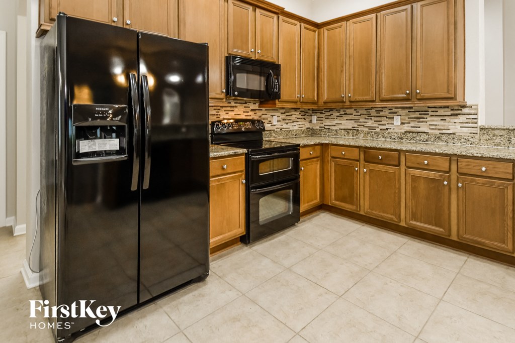 a kitchen with stainless steel appliances and wooden cabinets