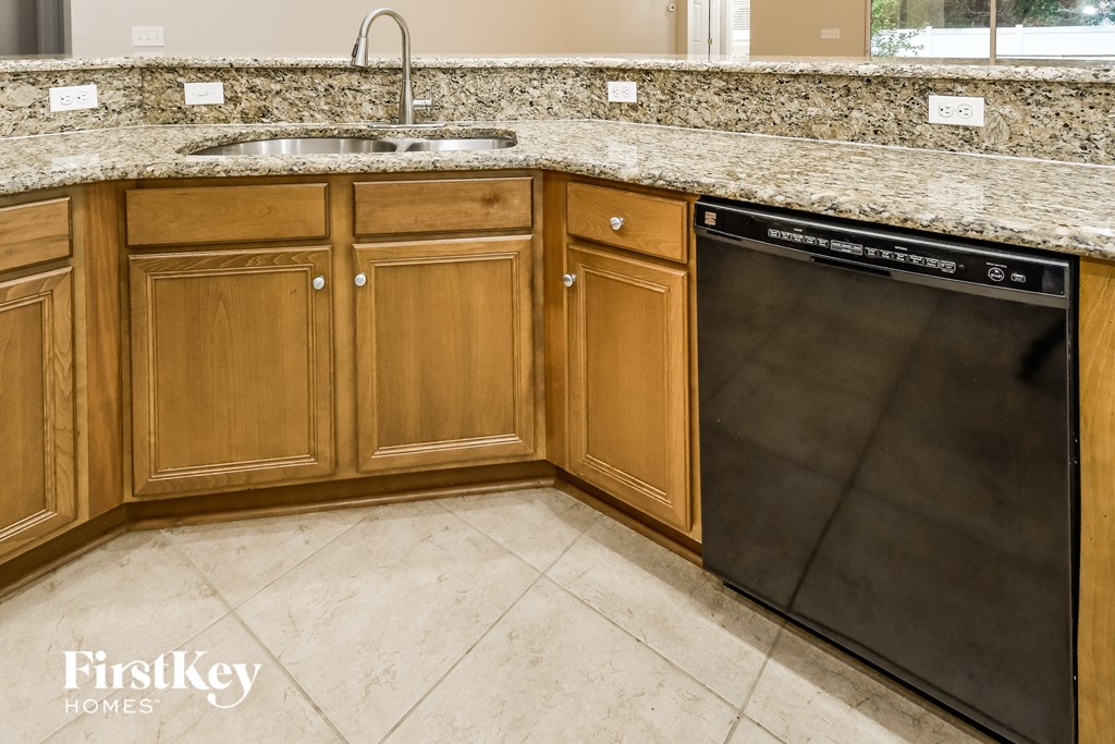 a kitchen with wooden cabinets and a dishwasher