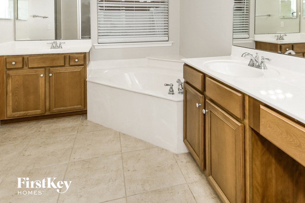 a bathroom with a large tub and two sinks