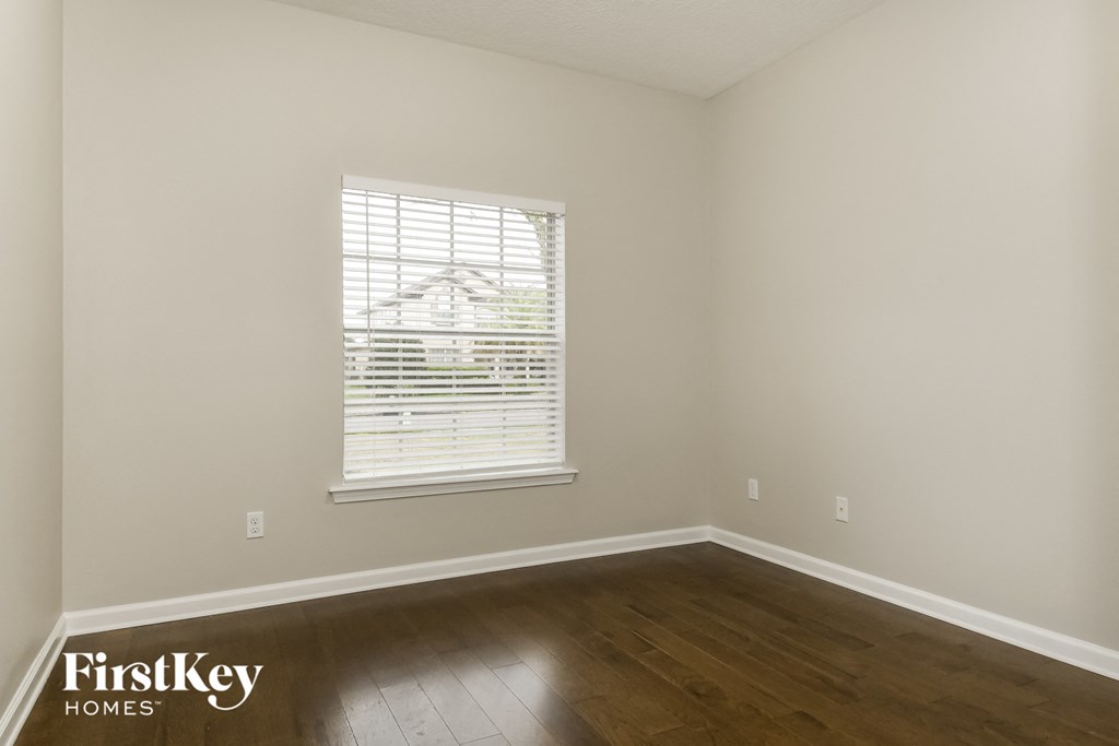 a living room with wood floors and a window