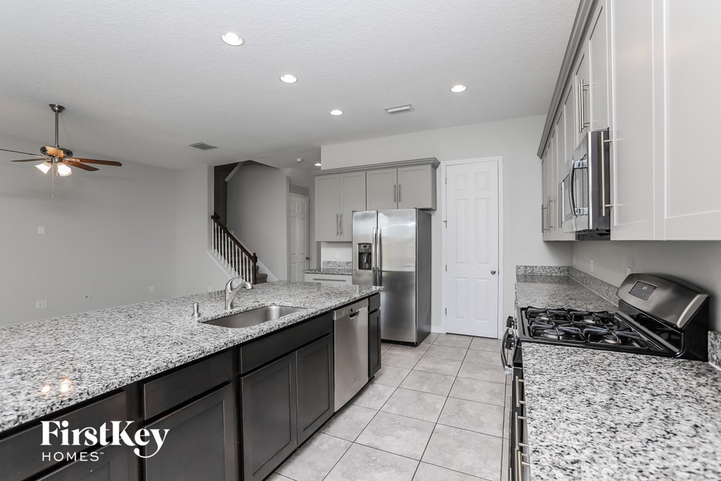 A kitchen with granite countertops and stainless steel appliances.