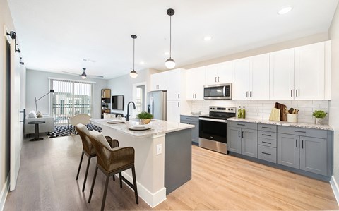 an open kitchen and living room with a table and chairs