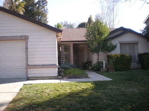 a house with a sidewalk in front of it