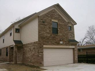 a brick house with a white garage door