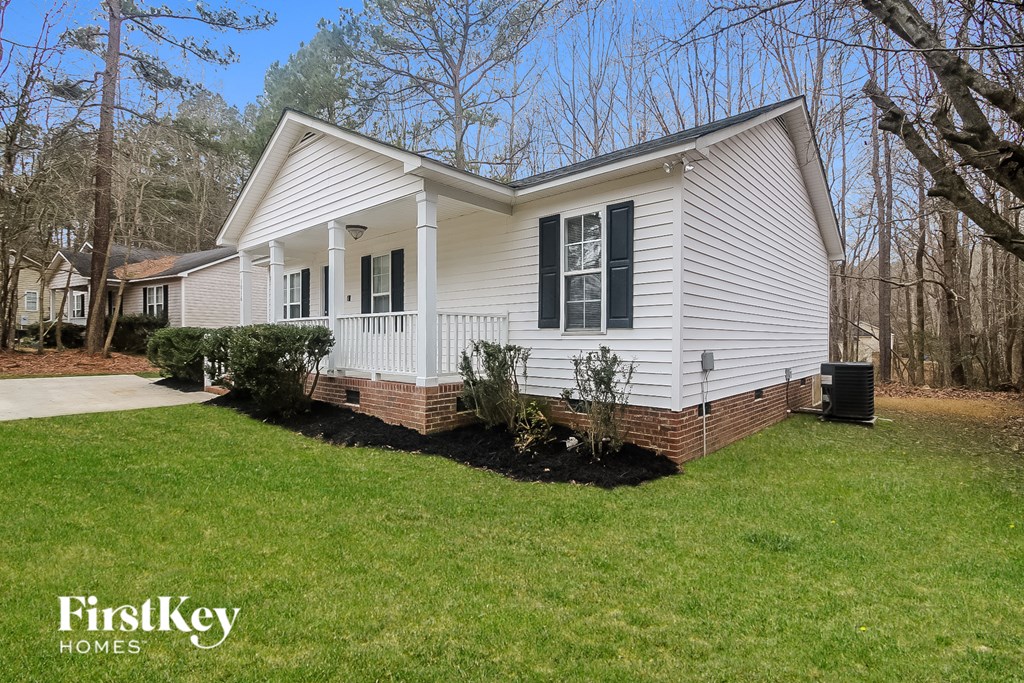 A white house with black shutters is for sale by FirstKey Homes.