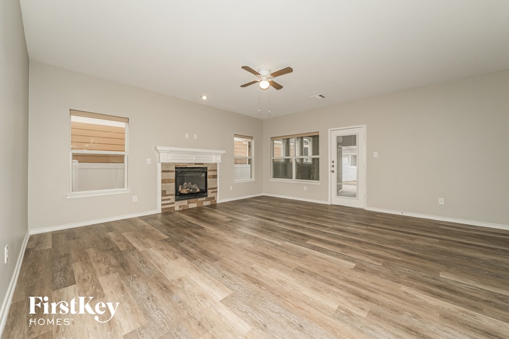 a living room with a fireplace and wooden floors