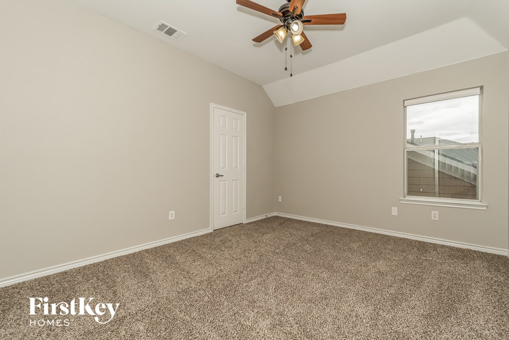 the master bedroom has a ceiling fan and carpeted flooring