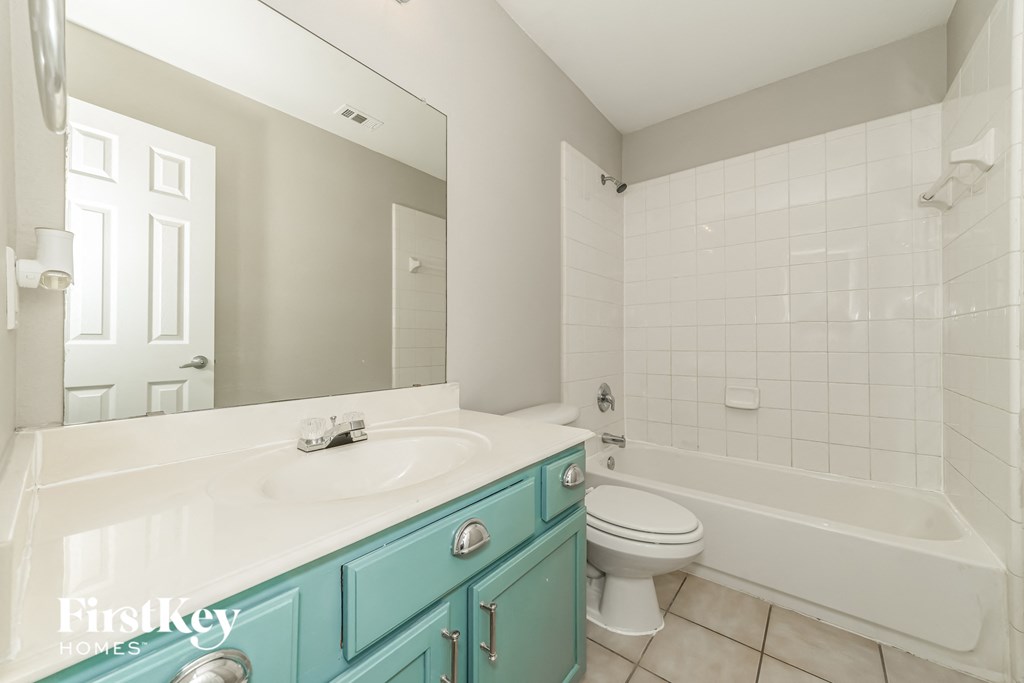 a bathroom with a sink and a toilet and a tub